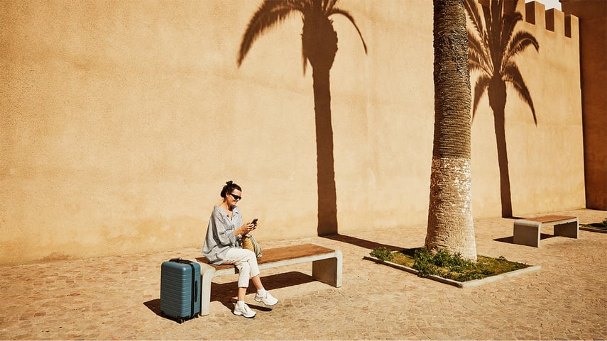 Extreme wide shot woman looking at smart phone while exploring Morocco - stock photo