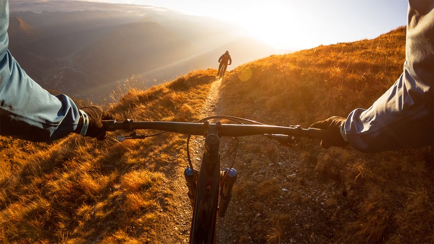 Cropped Image Of Man Riding Bicycle On Mountain - stock photo