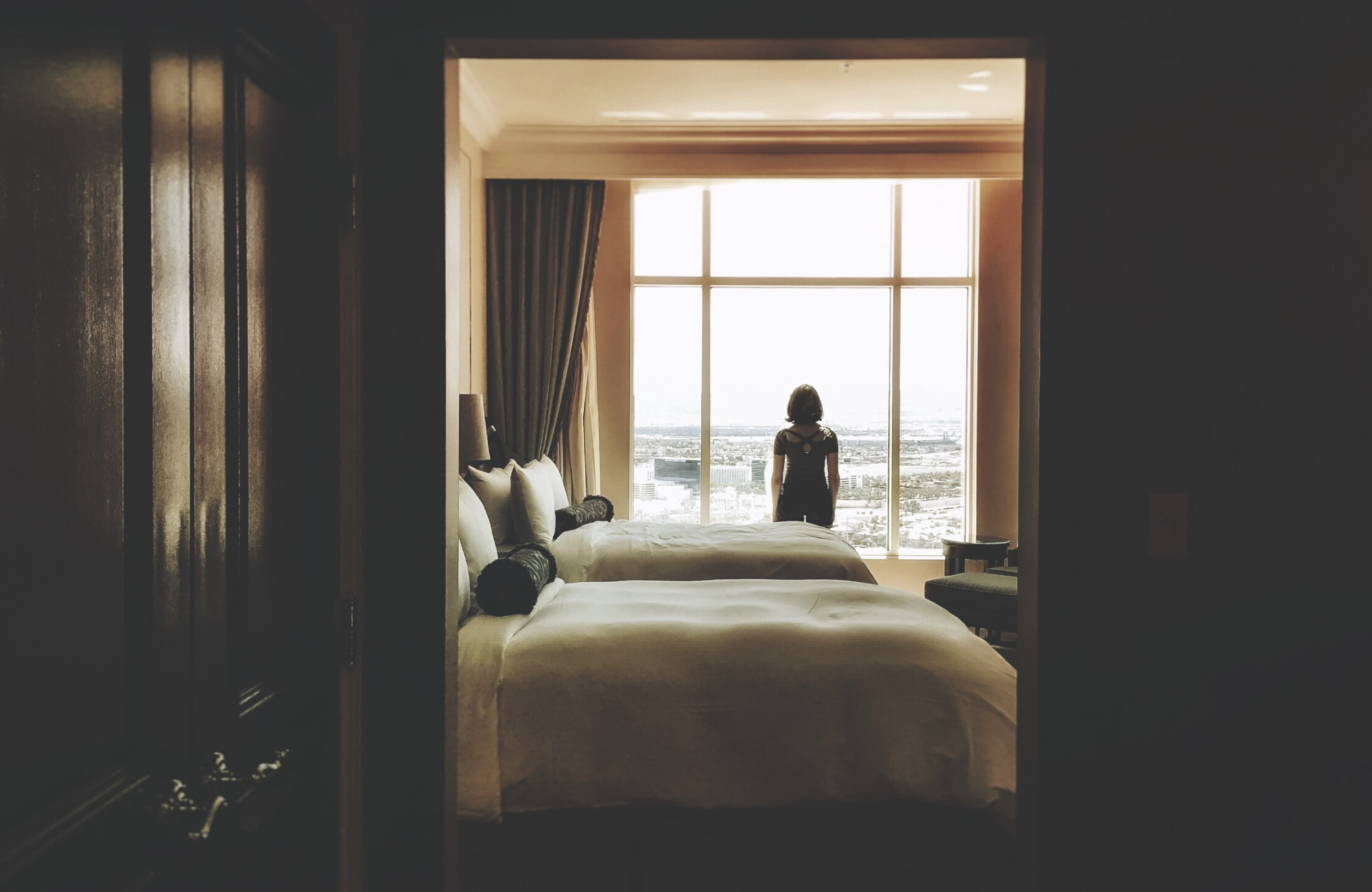 A woman looks out of a Las Vegas hotel room window