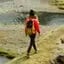 Woman walking across mountains
