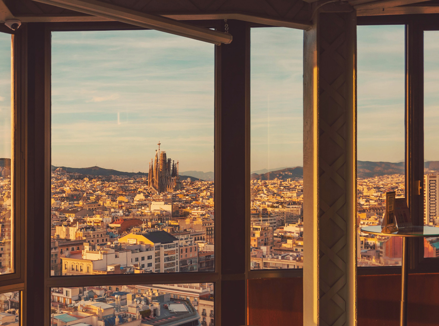 Panoramic view of Barcelona from a tall building, with La Sagrada Família visible in the distance. Panoramic view of Barcelona from a tall building, with La Sagrada Família visible in the distance.