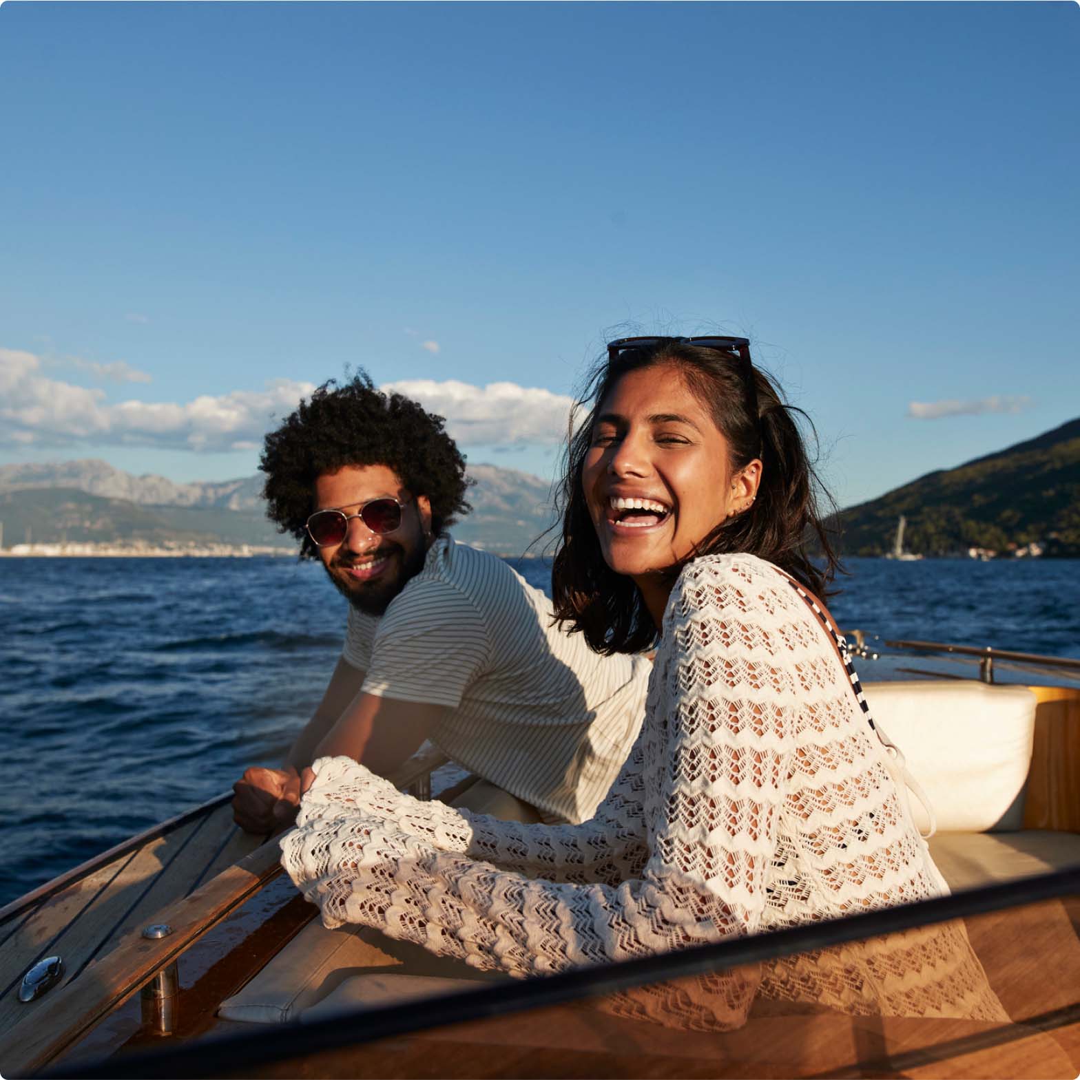 Happy couple smiling on a boat on a sunny day