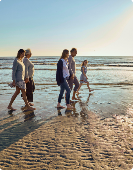 A family take a walk on the beach